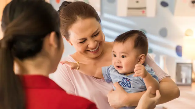 women holding a baby